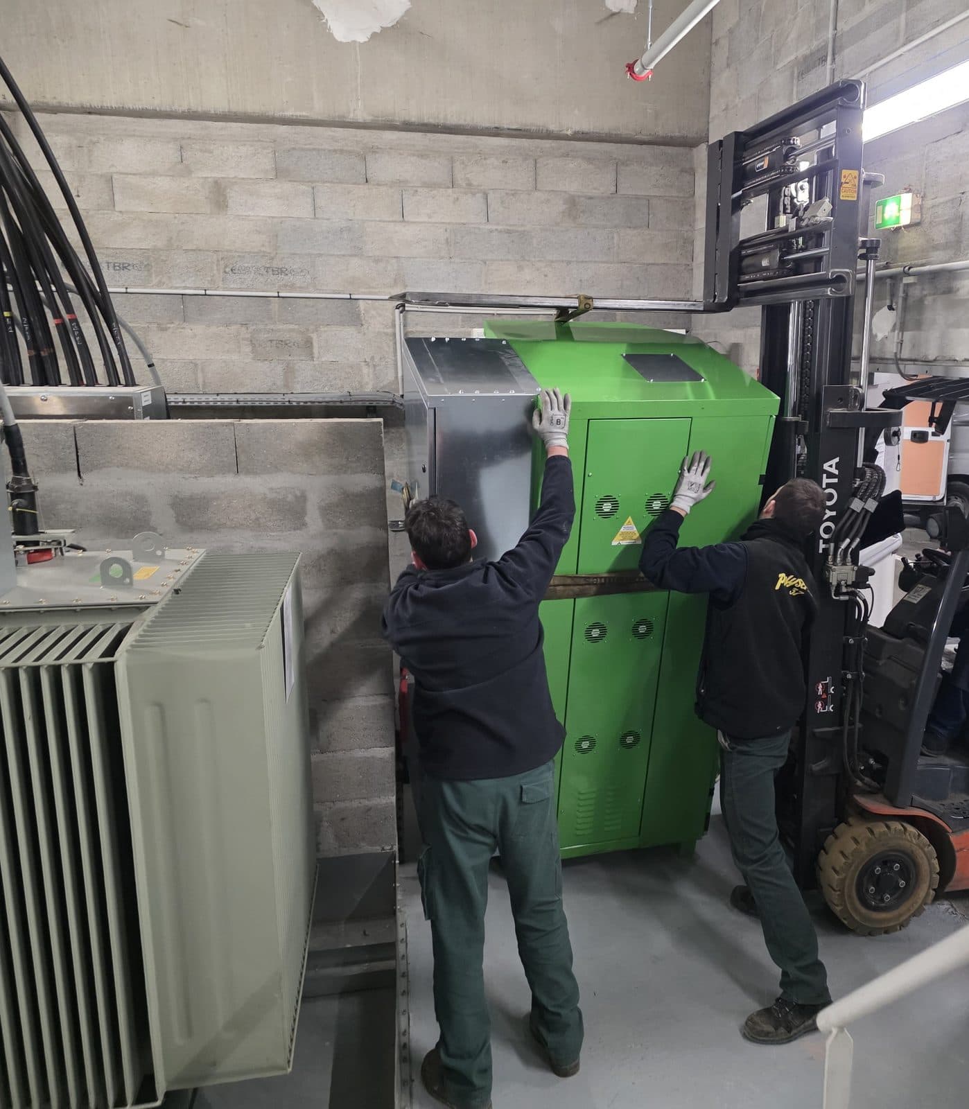 Icopower unit being moved into a plant room with a forklift