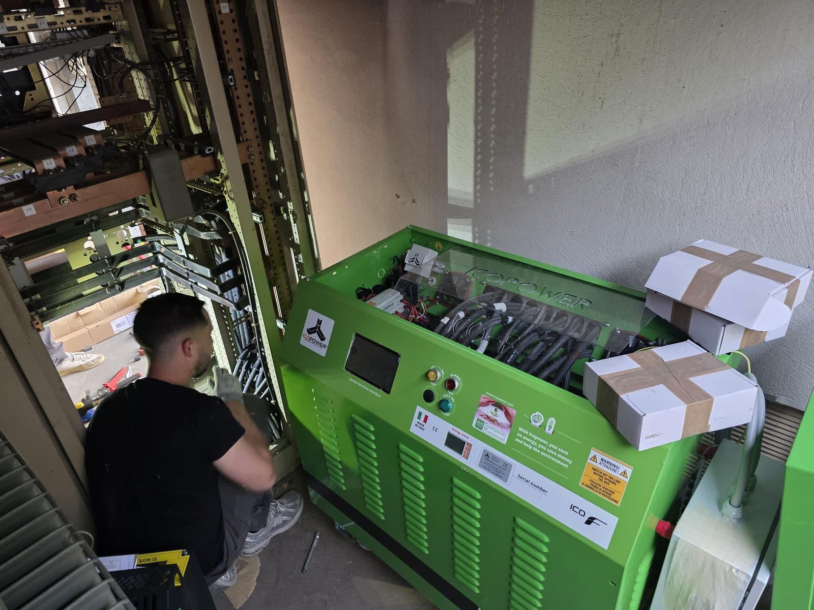 Technician connecting cables inside an Icopower unit