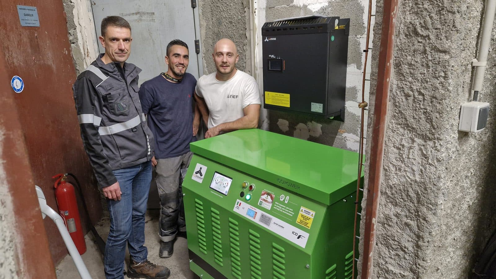 Installation crew next to an Icopower unit in a basement